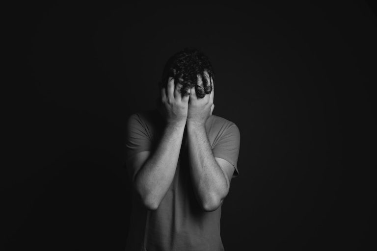 mad with hands over head