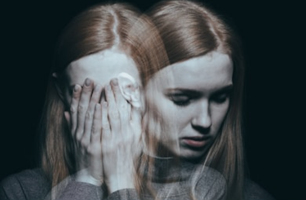 mirror image of woman holding hand on face